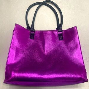 Tote bag with a bright magenta faux leather front.